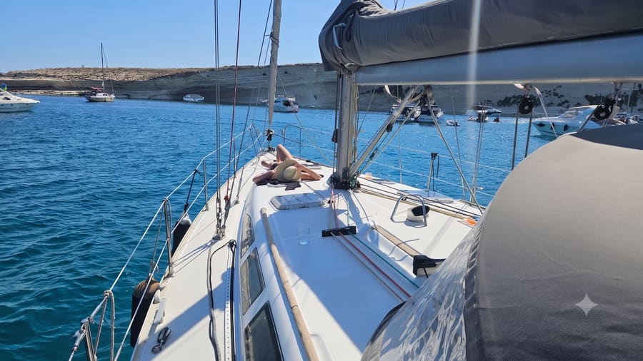 Guests relaxing on the foredeck at anchor