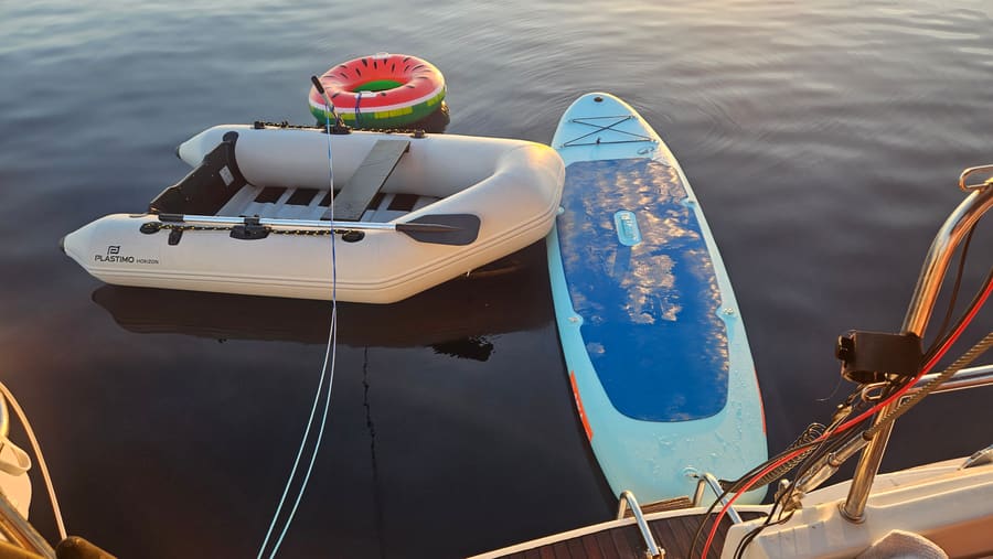 Dinghy, paddleboard and floats in turquoise water