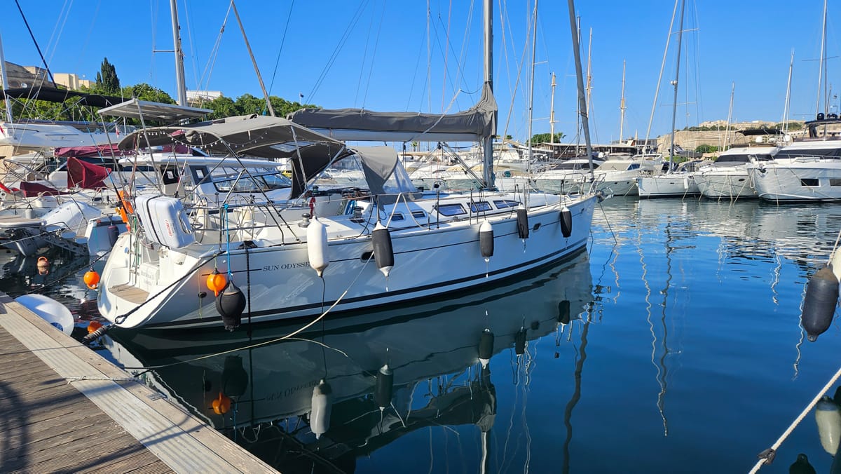 Valmera, a Jeanneau Sun Odyssey 43, moored on calm water